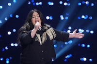 a woman singing into a microphone