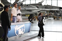 a group of people in an airplane hangar